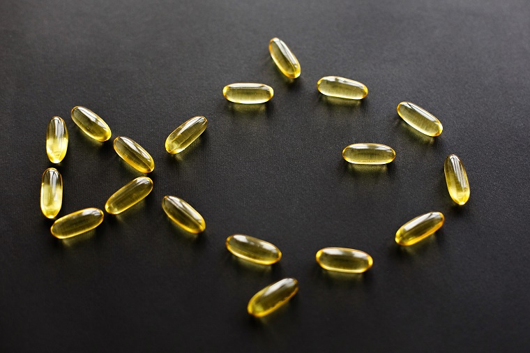 Fish oil capsules arranged in the shape of a fish