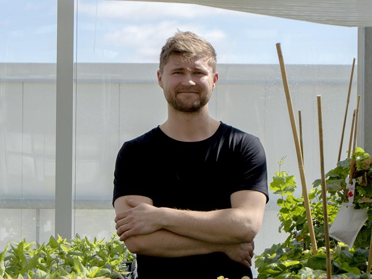 PhD student Michal Pyc in the Phytotron (photo by K. White)