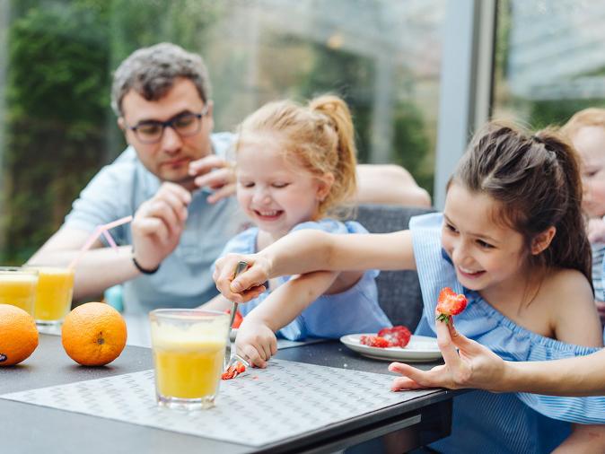 A family eating fruit and juice