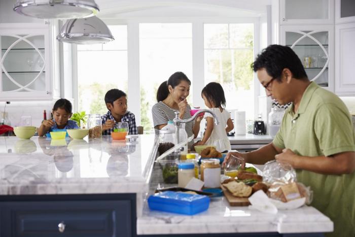 A family has breakfast in the kitchen