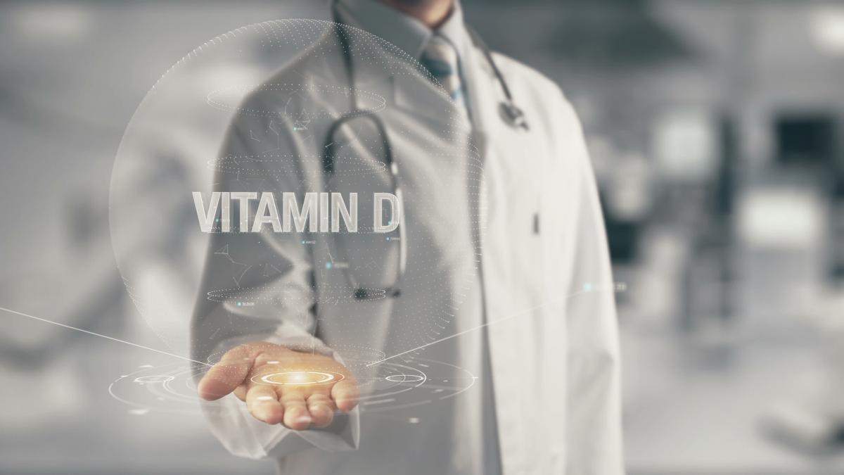 Medical professional extending hand offering vitamin D